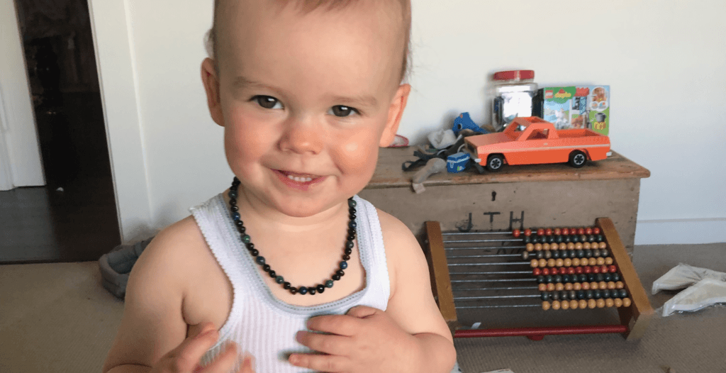 Baby with teeth and Baltic amber beads